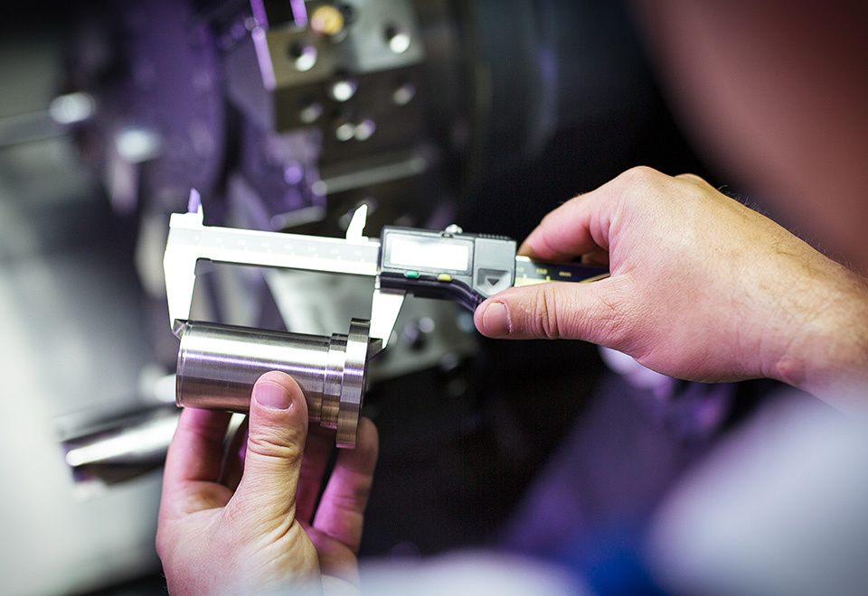 Worker measuring a made piece